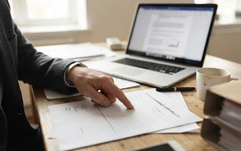 A person reviews a national police clearance certificate with a lawyer to understand what appears on it